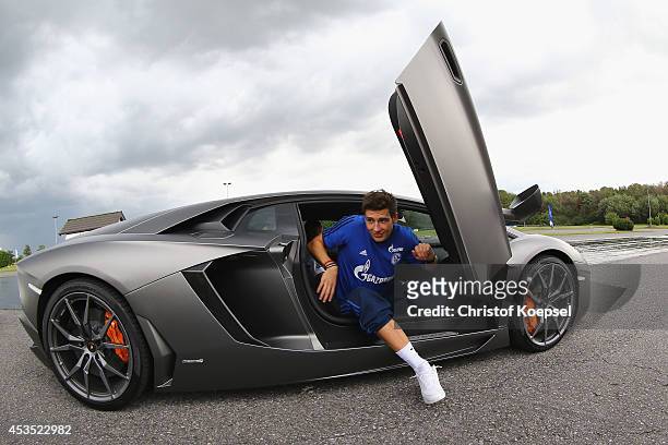 Leon Goretzka of Schalke walks out of a Lamborghini during a test drive at driving safety centre Rheinberg on August 12, 2014 in Rheinberg, Germany.