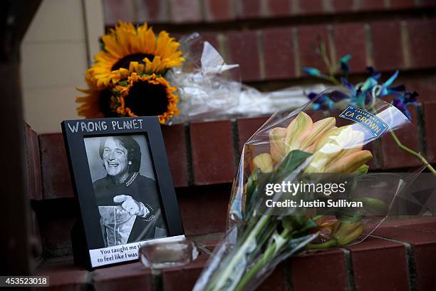 Flowers and pictures that are part of a growing memorial sit on the steps in front of the home where actor and comedian Robin Williams filmed the...