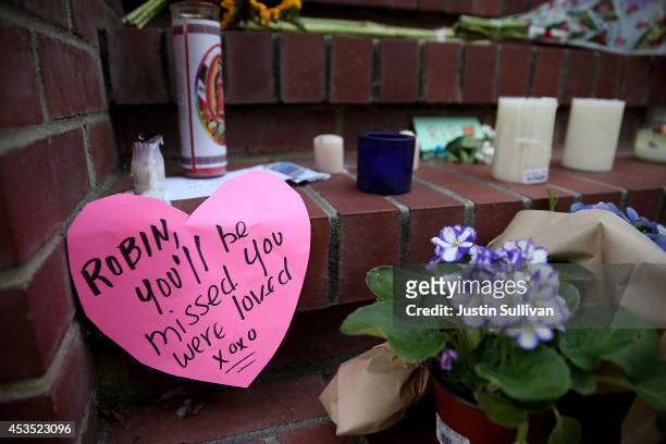 Flowers and pictures that are part of a growing memorial sit on the steps in front of the home where actor and comedian Robin Williams filmed the...