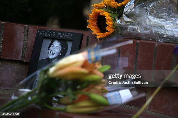 Flowers and pictures that are part of a growing memorial sit on the steps in front of the home where actor and comedian Robin Williams filmed the...
