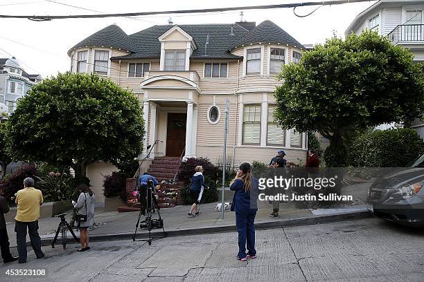 Well wishers and members of the media gather in front of the home where actor and comedian Robin Williams filmed the movie Mrs. Doubtfire on August...