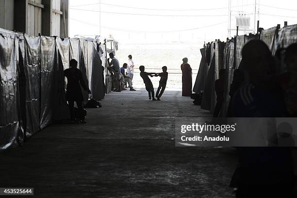 Iraqis including Turkmen, Shabaks, Kurds, Yezidis and Christians, fleeing from assaults of army groups led by Islamic State , take shelter at Bahirka...