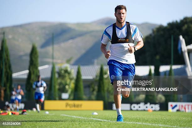 Marseille's French forward Andre-Pierre Gignac runs during a training session on August 12, 2014 at the Robert Louis-Dreyfus training centre in...