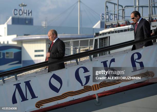 Russian President Vladimir Putin and Egyptian President Abdel Fattah el-Sisi leave the Black Sea Fleet's guards missile cruiser Moskva in the sea...