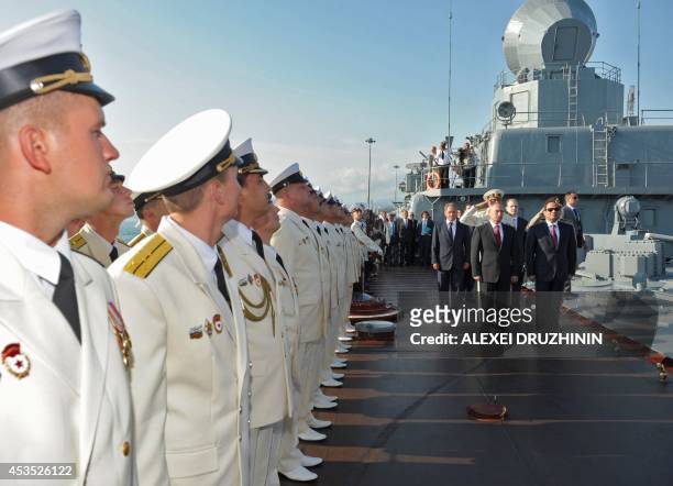 Russian President Vladimir Putin and Egyptian President Abdel Fattah el-Sisi inspect the guard of honour during their visit to the Black Sea Fleet's...
