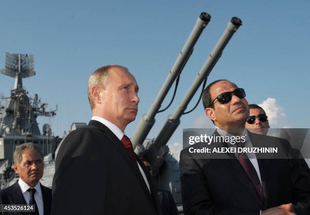 Russian President Vladimir Putin and Egyptian President Abdel Fattah el-Sisi listen to explanations during their visit to the Black Sea Fleet's...
