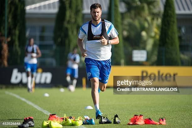 Marseille's French forward Andre-Pierre Gignac runs during a training session on August 12, 2014 at the Robert Louis-Dreyfus training centre in...