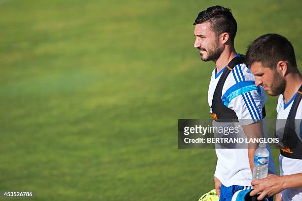 Marseille's French forward Andre-Pierre Gignac and French midfielder Romain Alessandrini walk during a training session on August 12, 2014 at the...