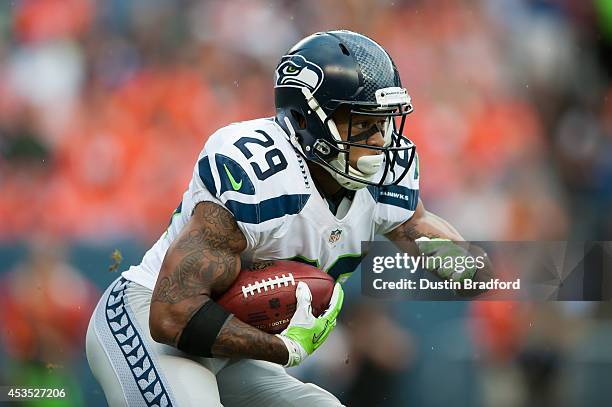 Free safety Earl Thomas of the Seattle Seahawks returns a punt against the Denver Broncos during preseason action at Sports Authority Field at Mile...