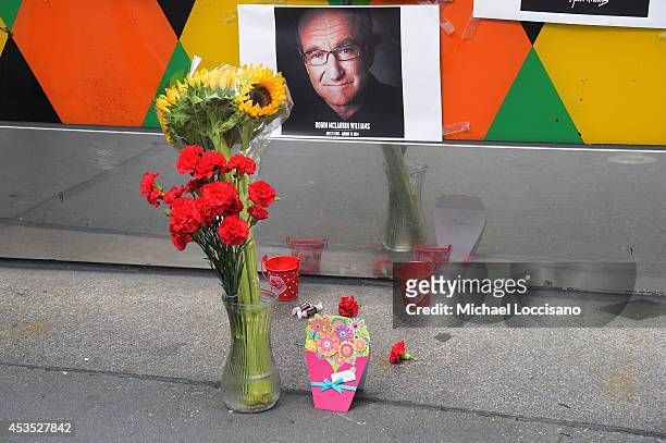 Flowers, tootsie rolls, a card, and a candle are placed in memory of Robin Williams in front of Carolines on Broadway comedy club on August 12, 2014...