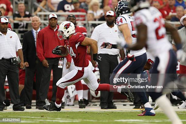 Tight end Rob Housler of the Arizona Cardinals runs with the football after a receptoin against the Houston Texans during the preseason NFL game at...