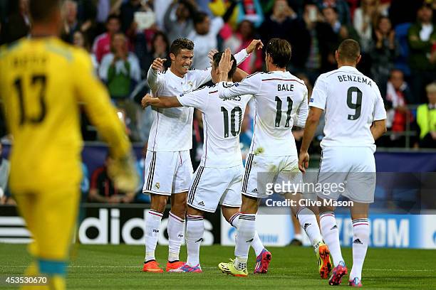 Cristiano Ronaldo of Real Madrid celebrates with teammates James Rodriguez, Gareth Bale and Karim Benzema after scoring the opening goal during the...