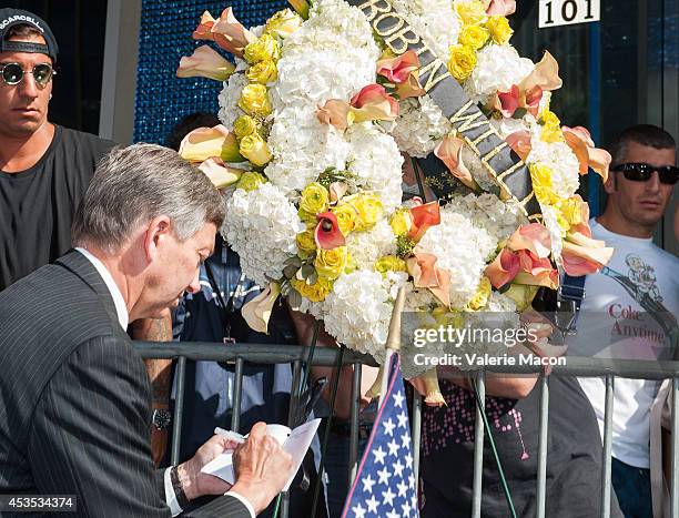 Hollywood Chamber of Comerce President & CEO Leron Gubler places Flowers on Robin Williams Hollywood Walk of Fame star on August 12, 2014 in Los...