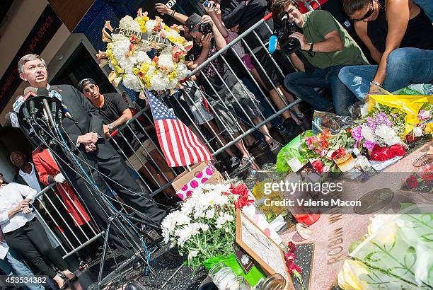 Hollywood Chamber of Comerce President & CEO Leron Gubler places Flowers on Robin Williams Hollywood Walk of Fame star on August 12, 2014 in Los...