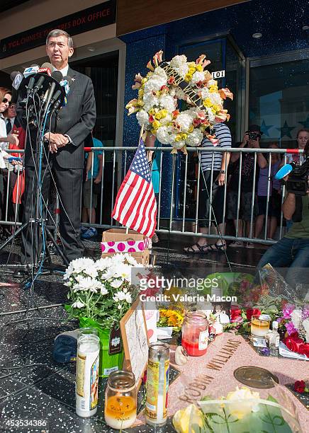 Hollywood Chamber of Comerce President & CEO Leron Gubler places Flowers on Robin Williams Hollywood Walk of Fame star on August 12, 2014 in Los...