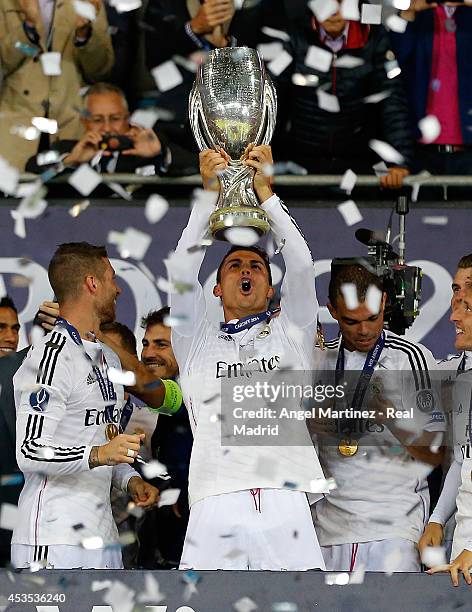 Cristiano Ronaldo of Real Madrid celebrates with the trophy after the UEFA Super Cup match between Real Madrid and Sevilla at Cardiff City Stadium on...