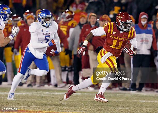 Tight end E.J. Bibbs of the Iowa State Cyclones rushes for yards past safety Isaiah Johnson of the Kansas Jayhawks in the first half of play at Jack...