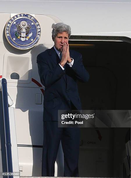 Secretary of State John Kerry waves to officials and guests before departing on August 13, 2014 in Sydney, Australia. US Secretary of State John...