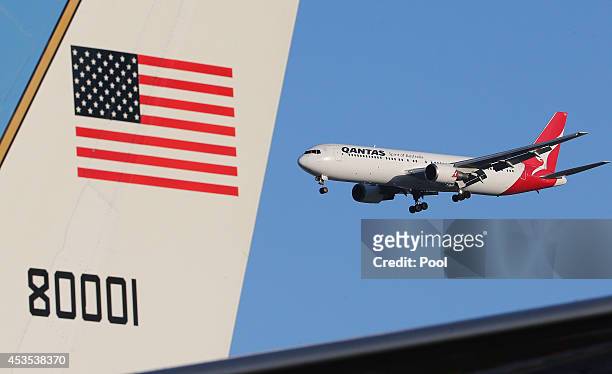 Jet flies past the plane of U.S. Secretary of State John Kerry before departing on August 13, 2014 in Sydney, Australia. US Secretary of State John...
