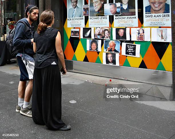 People gather near a makeshift memorial for Robin Williams in front of Carolines on Broadway comedy club on August 12, 2014 in New York City.