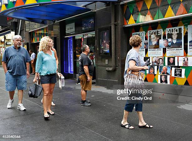 People gather near a makeshift memorial for Robin Williams in front of Carolines on Broadway comedy club on August 12, 2014 in New York City.