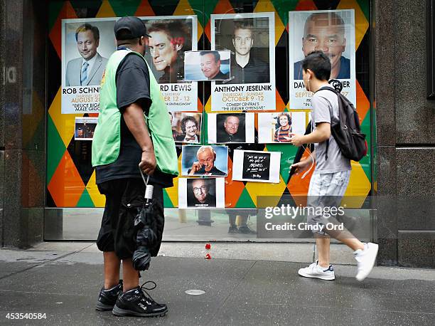 People gather near a makeshift memorial for Robin Williams in front of Carolines on Broadway comedy club on August 12, 2014 in New York City.