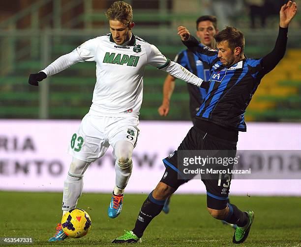 Antonio Floro Flores of US Sassuolo Calcio competes for the ball with Michele Canini of Atalanta BC during the Tim Cup match between Atalanta BC and...