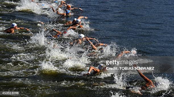 Athletes start the women's 10 km open water swimming event at the 32nd LEN European swimming championships on August 13, 2014 at the Regattastrecke...
