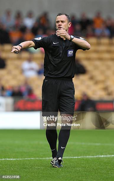 Referee Stuart Attwell in action during the Capital One Cup First Round match between Wolverhampton Wanderers and Northampton Town at Molineux on...