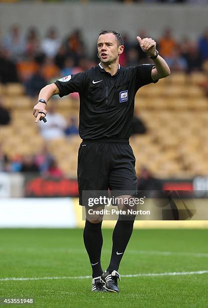 Referee Stuart Attwell in action during the Capital One Cup First Round match between Wolverhampton Wanderers and Northampton Town at Molineux on...