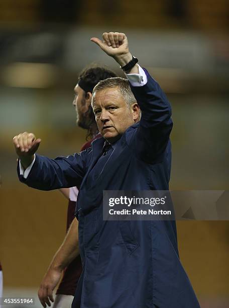 Northampton Town manager Chris Wilder acknowledges the fans at the end of the Capital One Cup First Round match between Wolverhampton Wanderers and...