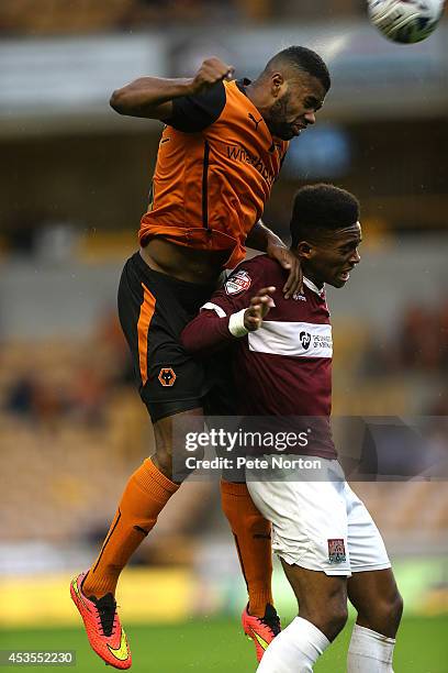 Ethan Ebanks-Landell of Wolverhampton Wanderers rises above Ivan Toney of Northampton Town to head the ball during the Capital One Cup First Round...