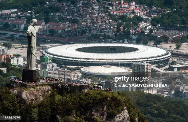 Aerial view of the Christ the Redeemer statue atop Corcovado Hill and the Mario Filho stadium in Rio de Janeiro, Brazil, on December 3, 2013. The...