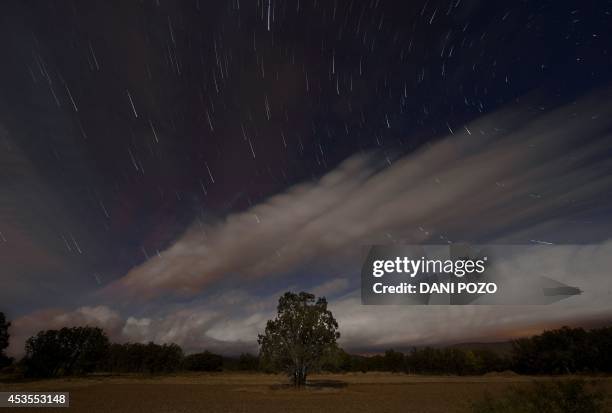 Multiple exposure picture taken in the early hours of August 12, 2014 shows a Perseids meteor shower in the night sky from the mountains of the...