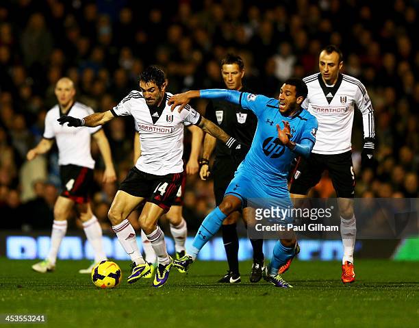 Giorgos Karagounis of Fulham holds off Etienne Capoue of Tottenham Hotspur during the Barclays Premier League match between Fulham and Tottenham...