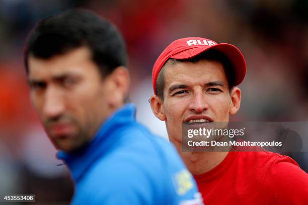 Ilya Shkurenyov of Russia looks on next to Oleksiy Kasyanov of Ukraine before competing in the Men's Decathlon Discus during day two of the 22nd...