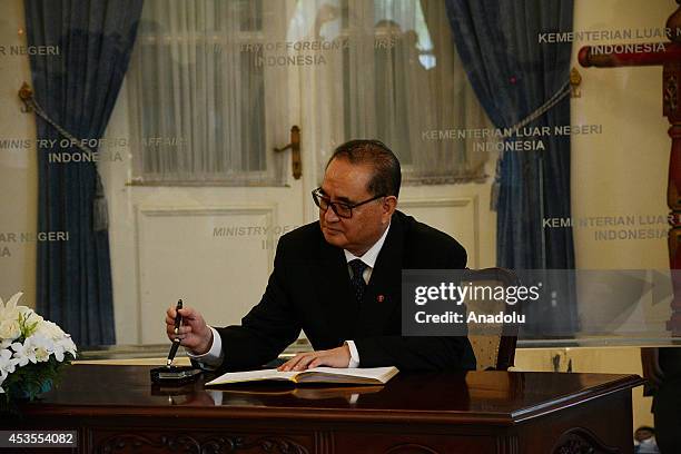 North Korea's Foreign Minister Ri Su Yong signs guest book before holding a meeting with his Indonesian counterpart Marty Natalegawa at the Ministry...