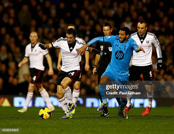 Giorgos Karagounis of Fulham holds off Etienne Capoue of Tottenham Hotspur during the Barclays Premier League match between Fulham and Tottenham...