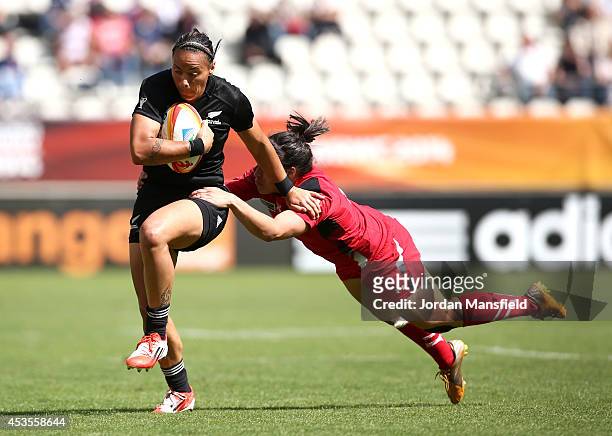 Honey Hireme of New Zealand is tackled by Rebecca De Filippo of Wales during the IRB Women's Rugby World Cup 5th place match between New Zealand and...