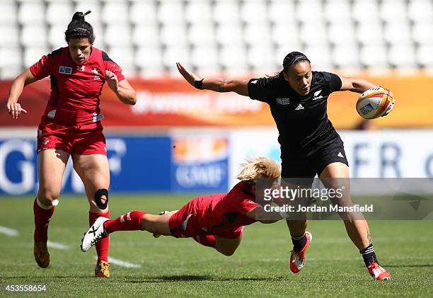 Honey Hireme of New Zealand is tackled by Philippa Tuttiett of Wales during the IRB Women's Rugby World Cup 5th place match between New Zealand and...