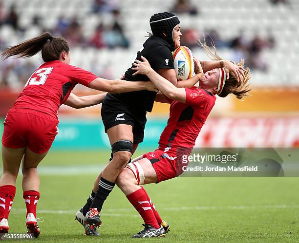 Rawina Everitt of New Zealand collides with Jenny Hawkins of Wales during the IRB Women's Rugby World Cup 5th place match between New Zealand and...