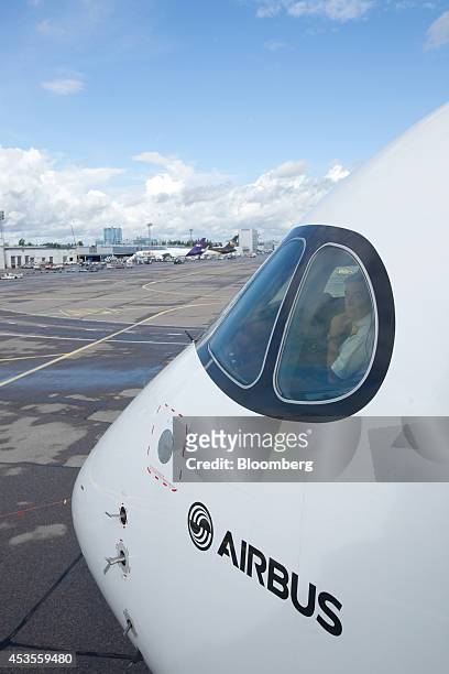 Aircrew sit in the cockpit of an Airbus A350 XWB aircraft operated by Finnair Oyj during a media event at Helsinki-Vantaa airport in Vantaa, Finland,...