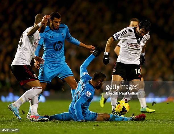 Giorgos Karagounis of Fulham is tackled by Sandro of Tottenham Hotspur during the Barclays Premier League match between Fulham and Tottenham Hotspur...