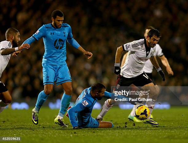 Giorgos Karagounis of Fulham is tackled by Sandro of Tottenham Hotspur during the Barclays Premier League match between Fulham and Tottenham Hotspur...