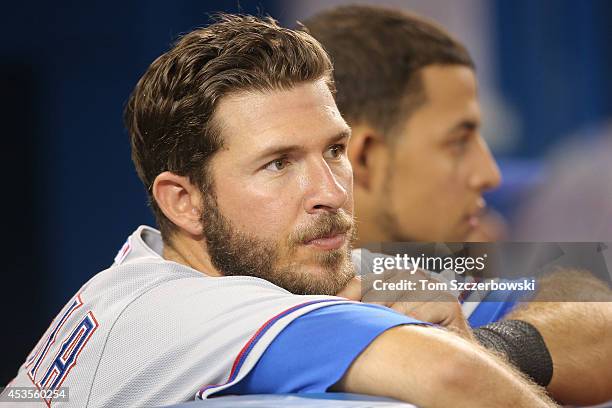 Arencibia of the Texas Rangers looks on from the dugout during MLB game action against the Toronto Blue Jays on July 19, 2014 at Rogers Centre in...