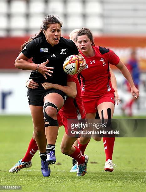 Shakira Baker of New Zealand is tackled by Adriana Taviner of Wales during the IRB Women's Rugby World Cup 5th place match between New Zealand and...