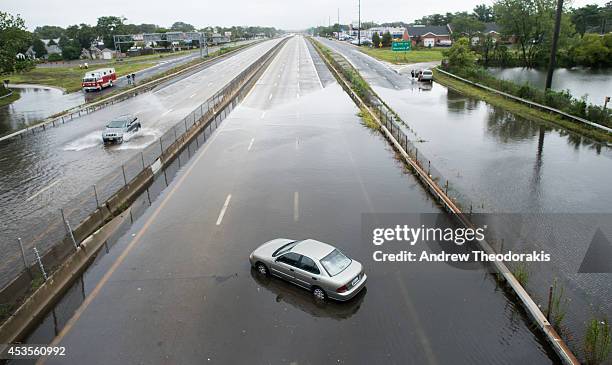 Car is abandoned on a flooded street at Sunrise Highway following heavy rains and flash flooding August 13, 2014 in Bayshore, New York. The south...