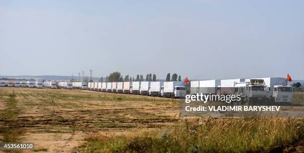 Trucks of Russian humanitarian convoy wait at the location outside Voronezh some 400 km outside Moscow on August 13, 2014. A massive Russian aid...