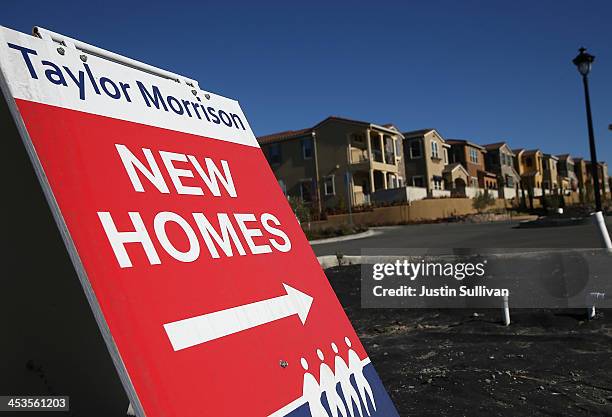 Sign advertising new homes is posted at a housing development on December 4, 2013 in Dublin, California. According to a Commerce Department report,...