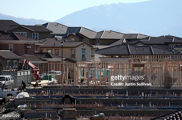Construction crews work on new homes at a housing development on December 4, 2013 in Dublin, California. According to a Commerce Department report,...